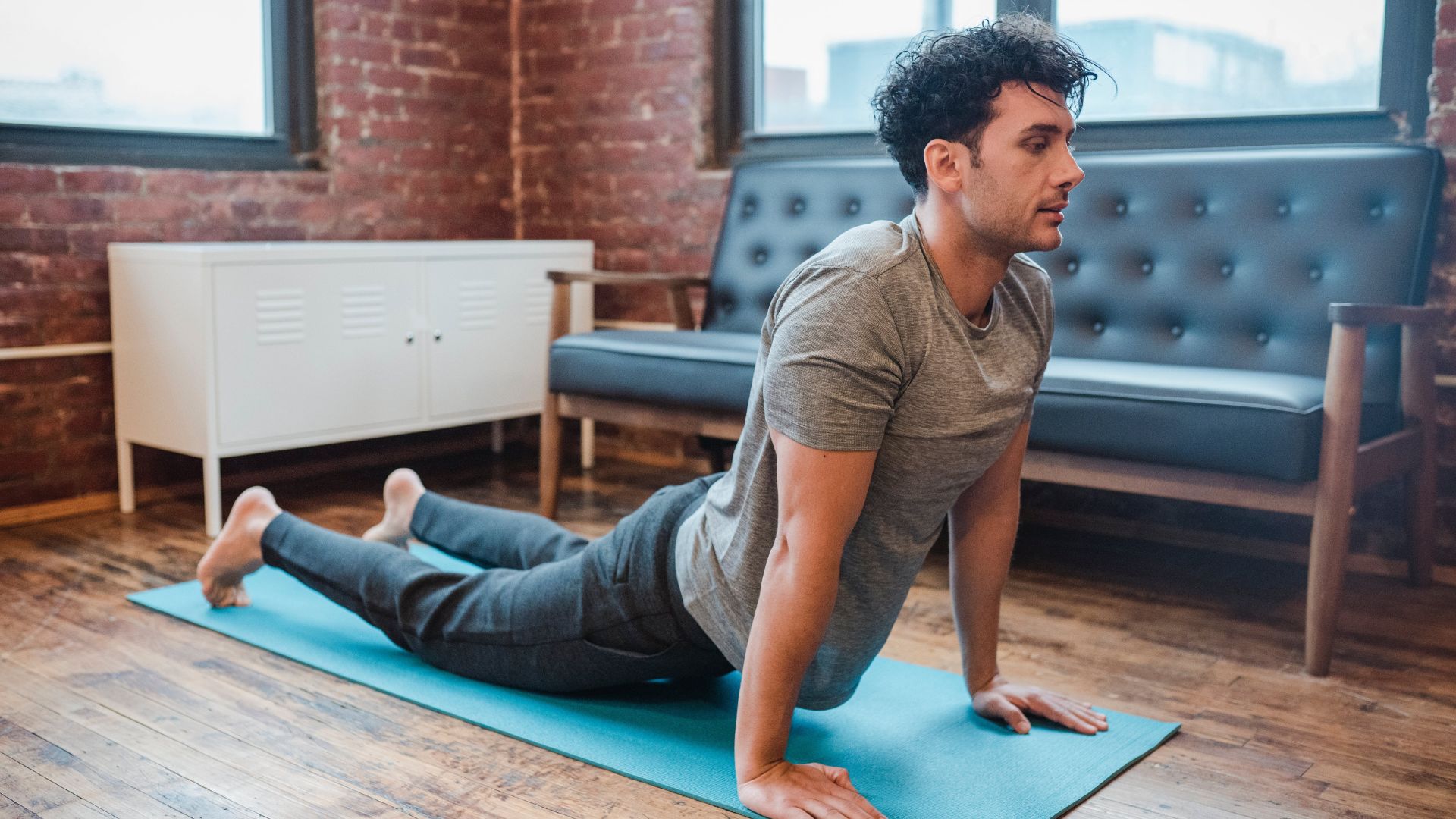 A man on a Yoga mat doing yoga