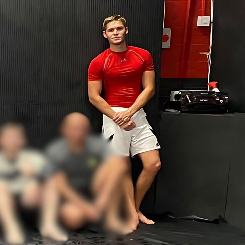 James, one of the founders of Optimal Combat posing in a photo at a gym